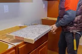 Installing granite countertop in kitchen.