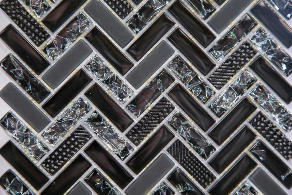 Black and silver geometric mosaic tile pattern.