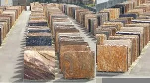Rows of stacked stone slabs outdoors.