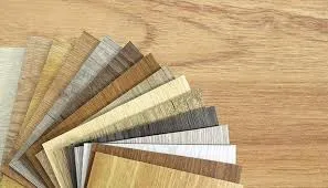 Wood veneer samples fanned on wooden surface.