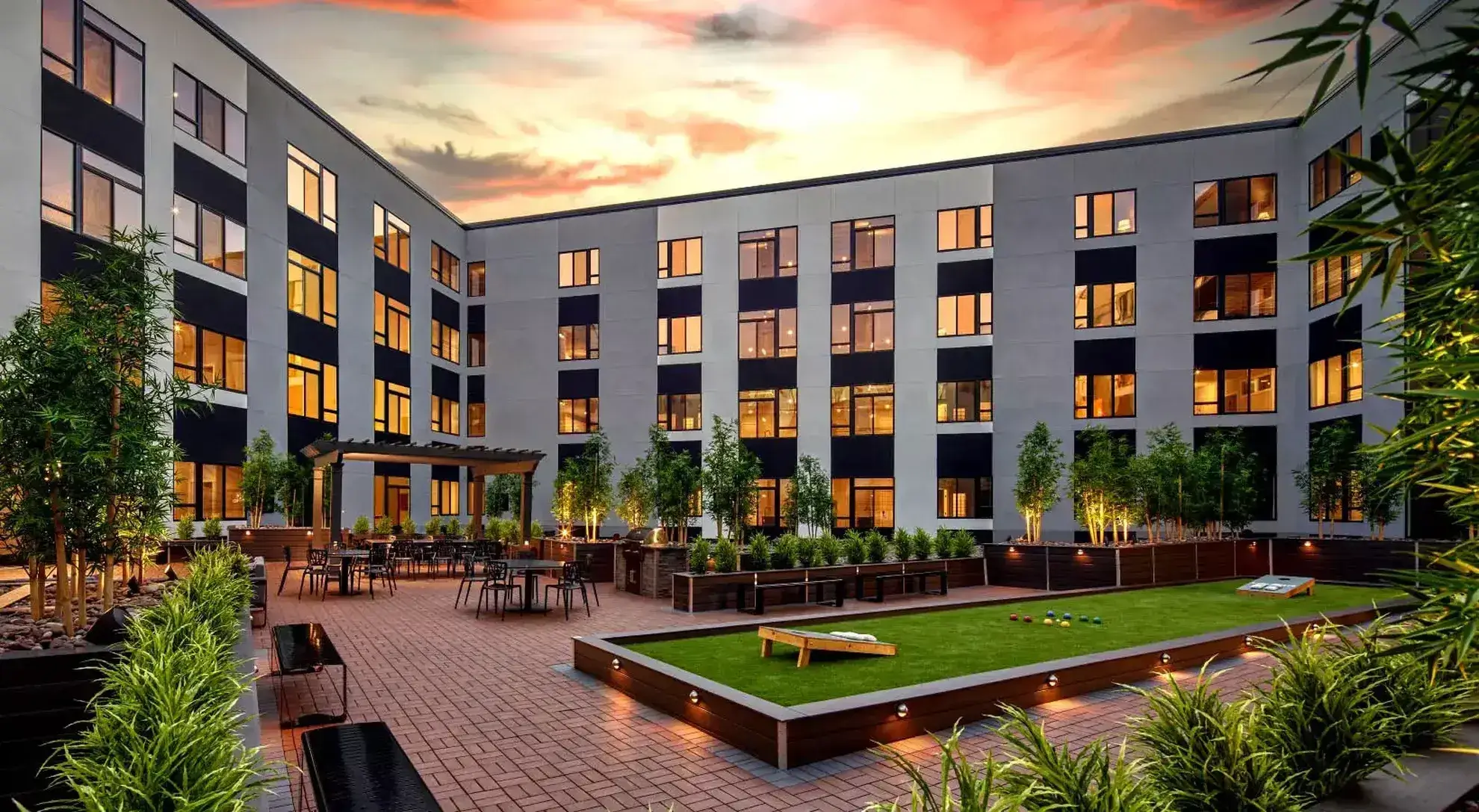 Modern courtyard with seating at sunset.