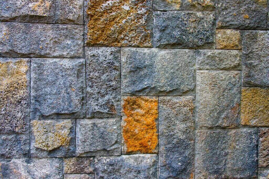Stone wall with various textured blocks.