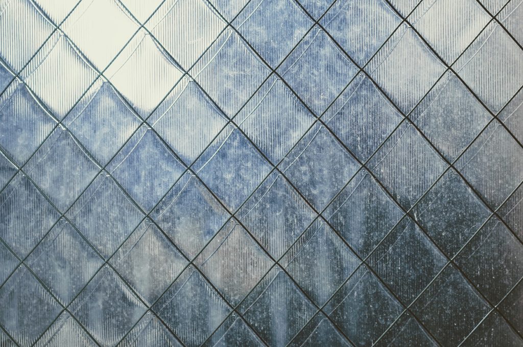 Diamond-patterned frosted glass with textured surface.