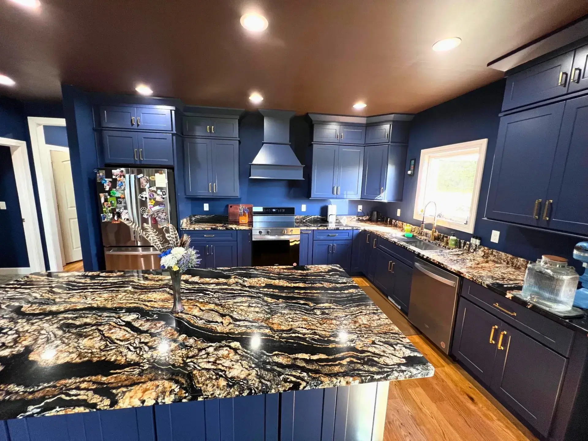 Modern kitchen with dark blue cabinets.