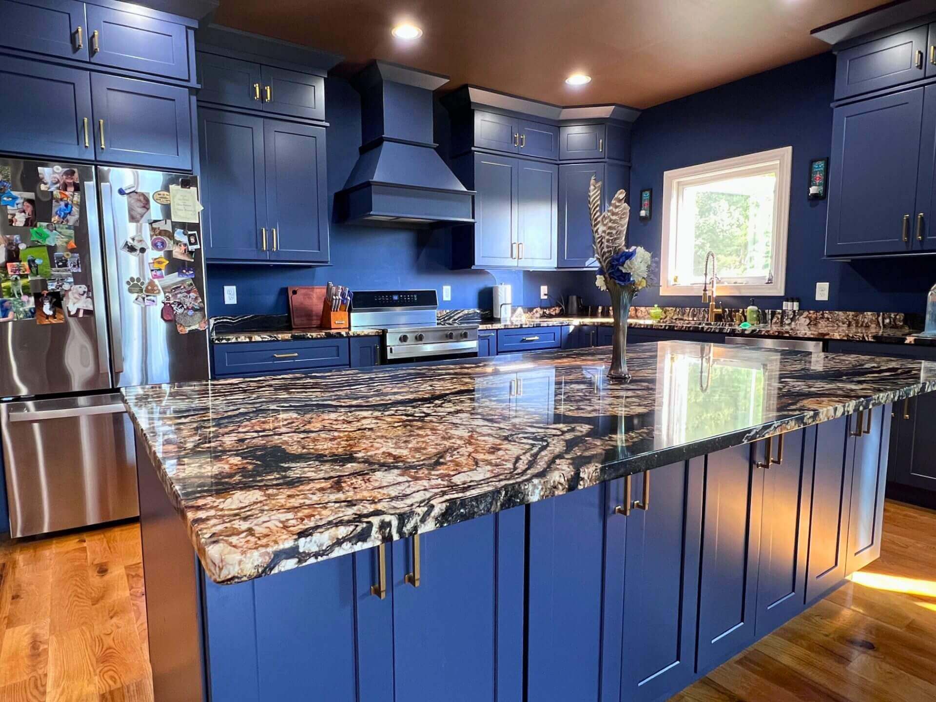 Modern kitchen with blue cabinets and island.