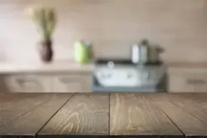 Wooden countertop with blurred kitchen background.