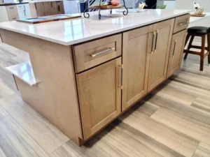 Modern island on gray wood plank flooring