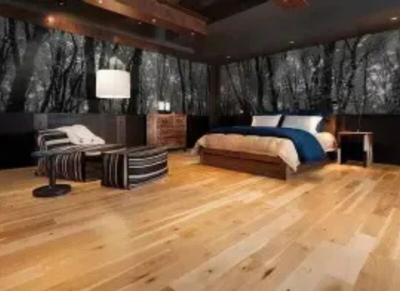 Modern bedroom with forest-themed wallpaper.