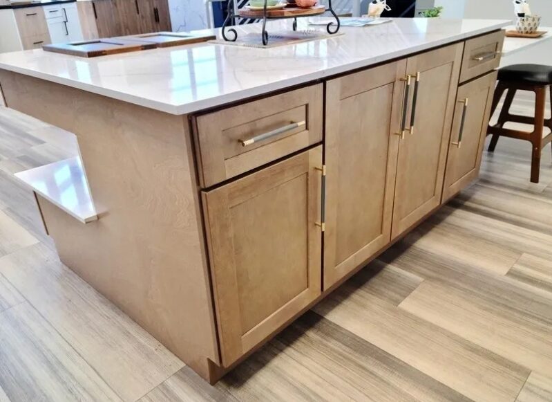 Wooden kitchen island with marble countertop.
