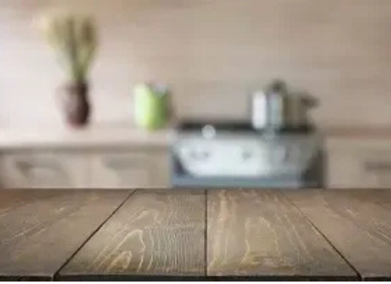 Wooden table in a blurred kitchen background.