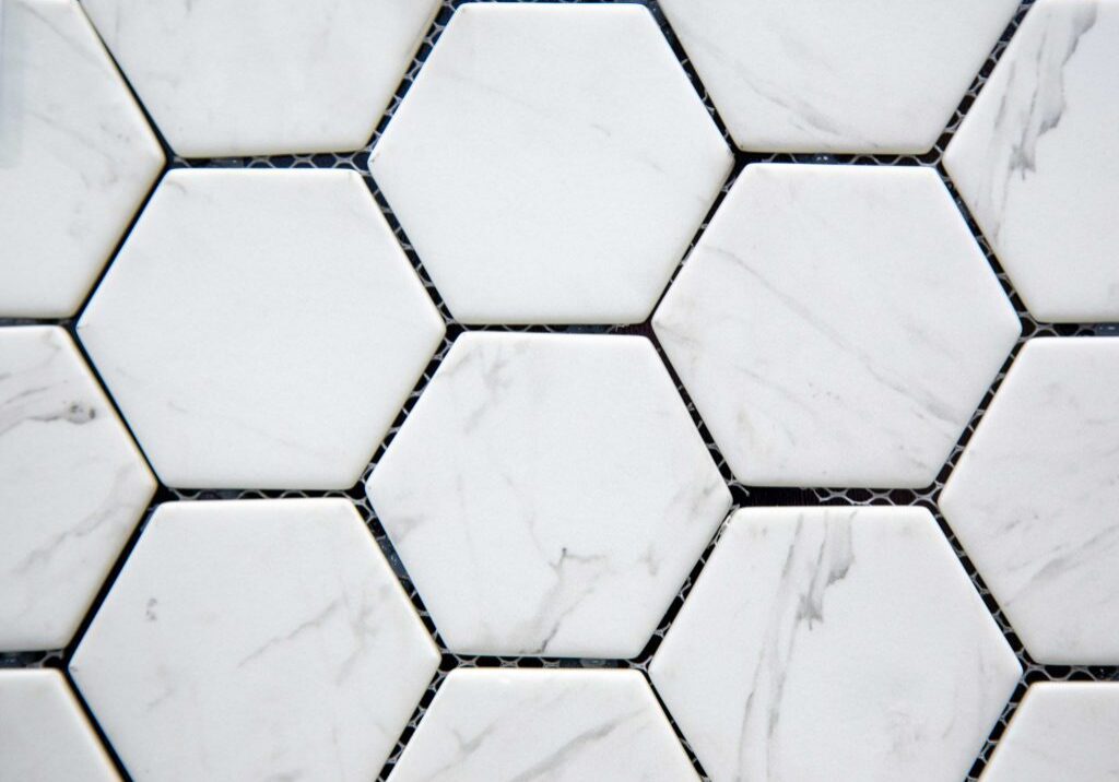 Hexagonal white tiles with subtle gray veins.