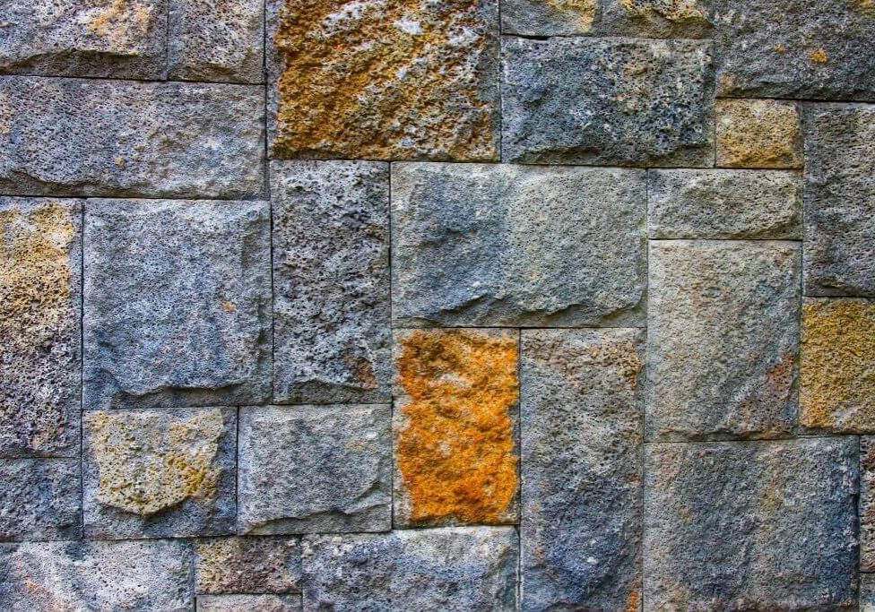 Stone wall with various textured blocks.