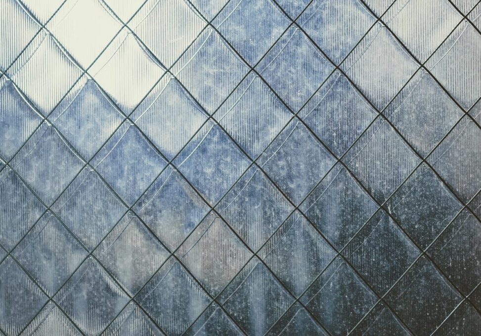 Diamond-patterned frosted glass with textured surface.